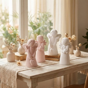 Set of four abstract angel resin figures in pink and white with delicate wings