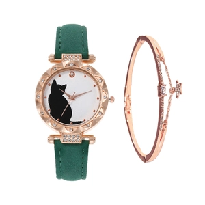 Detail of rose gold cat watch with green strap and star charm bracelet set