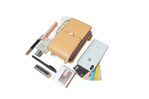 Detailed interior storage view of the tan PU leather crossbody phone bag with leaf buckle