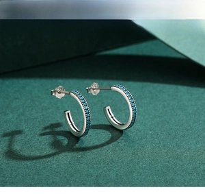 Close-up of S925 sterling silver C-shaped stud earrings with turquoise inlay details