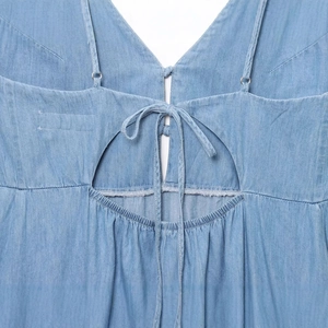 Back detail of a light blue V-neck midi dress with bow tie and adjustable straps