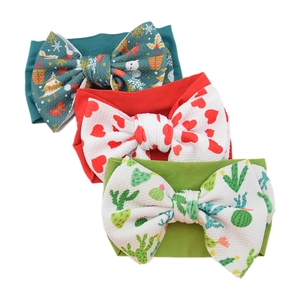 Three-pack of textured nylon baby headbands with festive Christmas, heart, and cactus prints
