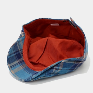 Blue plaid cotton ivy cap with orange lining shown from a top-down interior angle