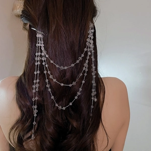 Detail showing elegant multi-layer pearl fringe hair chain draped on long hair