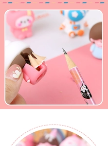 Close-up of pink cartoon pencil sharpener being used to sharpen a wooden pencil