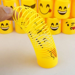 Stretchy yellow plastic spring toy with various emoji faces and colorful rainbow design