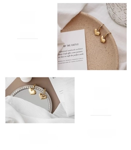Detail view of 18K gold plated heart earrings in 316L stainless steel, 1.5x1.1cm