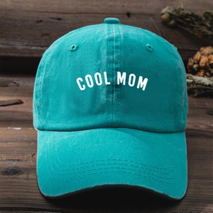 Vintage mint green COOL MOM embroidery washed cotton baseball cap on wood background