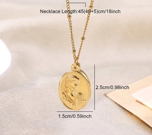 Macro detail of golden embossed goddess necklace pendant showing 45cm chain dimensions