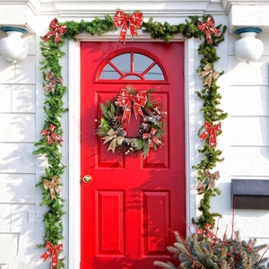 Christmas wreath with red tree print bows and vintage linen ribbons on a green garland