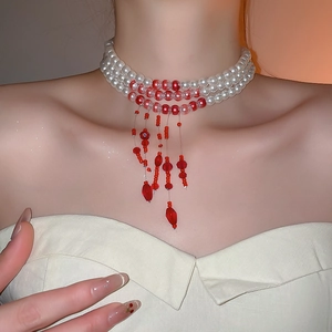 Elegant multi-layer pearl choker with red beads and fringe drop on a model