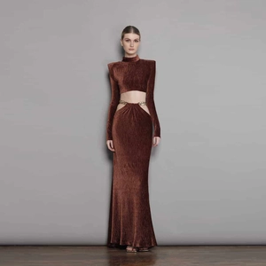 Women's brown velvet long sleeve crop top and high-waist maxi skirt set with metal chains