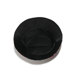 Detailed view of reversible sun hat with colorful floral print and solid black inner lining