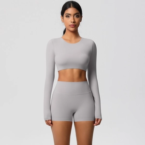 Detail of light grey seamless yoga set showing high waist shorts and cropped long sleeve