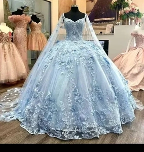 Close-up of light blue Quinceañera dress featuring detailed 3D butterfly and floral appliques