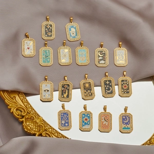 Tarot sun and moon gold pendants with colorful enamel and crystal accents on silk