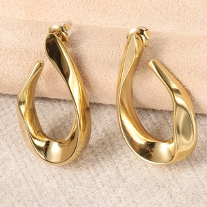 Detailed view of gold distorted waterdrop earrings with soft studio lighting