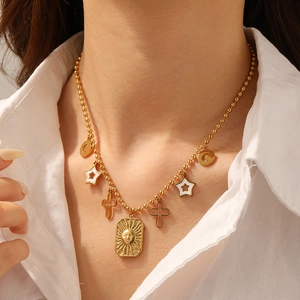 Detailed view of a gold-plated stainless steel bead chain necklace with multi-charms on model