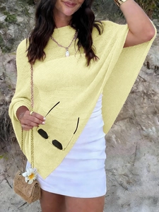 Detail of the light yellow textured fabric of this casual vacation poncho for women at beach