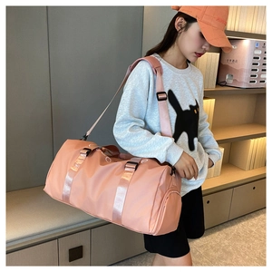 Pink waterproof nylon gym bag with dry-wet separation pocket and shoulder strap detail