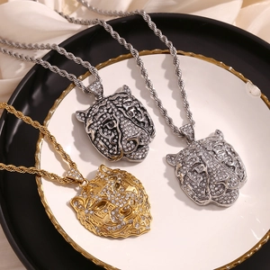 Macro shot of hip hop tiger head pendants with white zircons on twisted rope chains