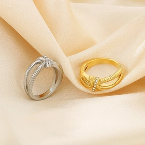 Detail of twisted rope knot rings in gold and silver finish with rhinestone inlay