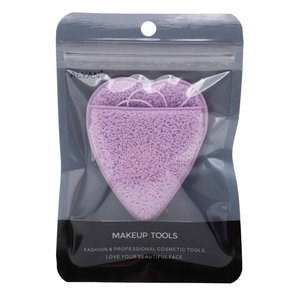 Detail of a purple heart-shaped makeup sponge in clear packaging with ALYAN branding
