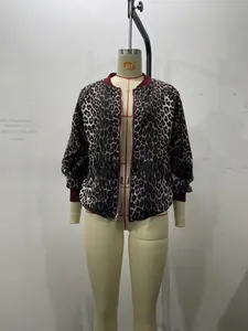 Detail of burgundy ribbed cuffs and leopard print pattern on a reversible jacket