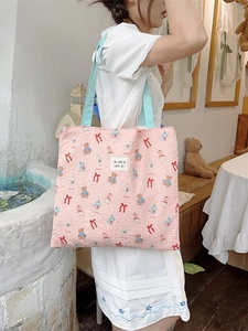 Pink quilted tote bag with cute bear pattern and light blue straps for students