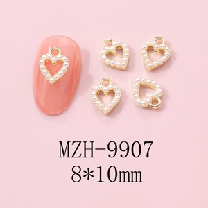 Detail of 8x10mm gold alloy heart nail charms with pearls on pink nails