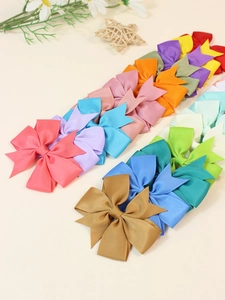 Close-up of assorted candy-colored ribbed polyester 8cm hair bow clips set in a row
