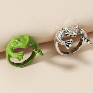 Macro detail of frog rings in green enamel and antique silver finish with open band