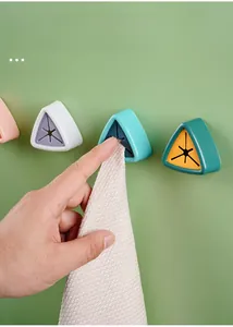 Macro detail of wall-mounted towel holders in four colors with silicone plug insert