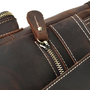 Detailed macro shot of vintage crazy horse leather stitching and brass metal zipper