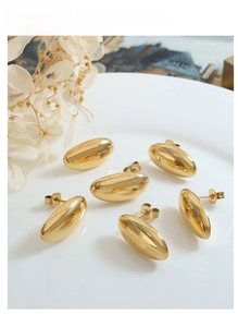 Detailed view of polished 18K gold-plated stainless steel rice grain stud earrings