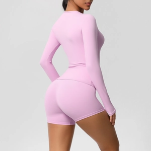 Detail of pink long sleeve yoga top and high waist shorts with soft brushed fabric texture