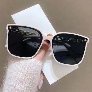 White oversized square sunglasses with gold chain detail and dark polarized lenses