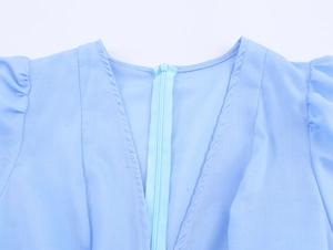 Detail shot of the invisible zipper and pleated shoulder on this light blue summer dress