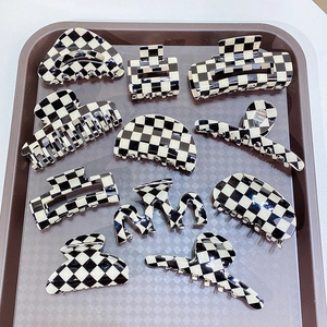Retro black and white checkered hair claw clips set in various geometric shapes