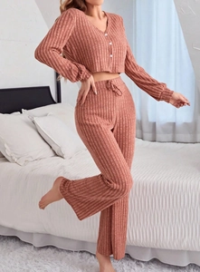 Detail of ribbed knit texture on mauve pajama set with white buttons and drawstring waist