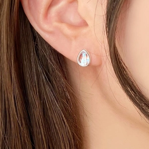 Close-up of 925 sterling silver teardrop earring with iridescent rainbow gemstone