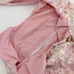 Close-up of pink lace shoulder bag interior with secure zipper pocket and lining