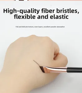Macro shot of an angled eyeliner brush creating a precise line on skin for makeup