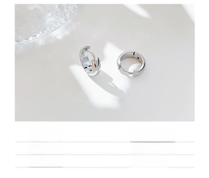 Detail of titanium steel hoop earrings featuring high-polish vacuum plating finish
