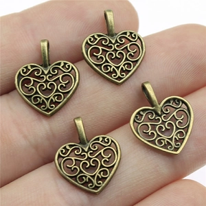 Antique bronze heart pendants shown on fingers for 16x14mm size reference and metal texture