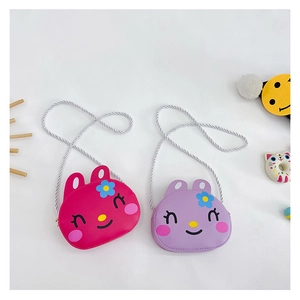 Detailed top view of purple and rose red cartoon rabbit crossbody bags with woven straps