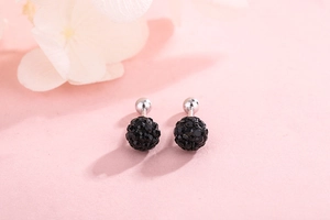 Macro shot of S925 silver screw back earrings featuring sparkling black pave crystal balls