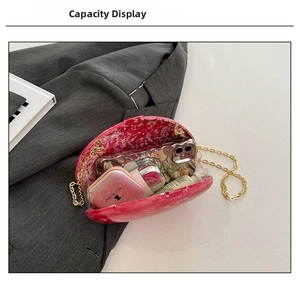 Internal view of acrylic shell clutch bag showing storage space for phone and makeup
