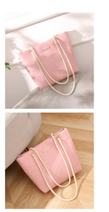 Close-up of pink chevron quilted tote bag with chunky cream rope handles and metal logo