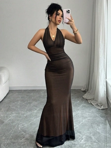 Detail of dark brown halter mesh maxi dress with textured pleats and bodycon silhouette